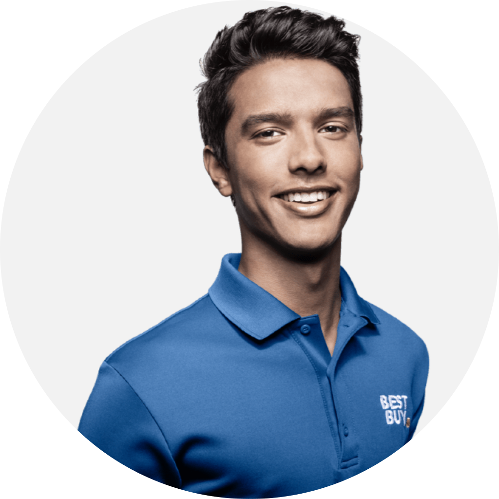 Employee wearing blue shirt with welcoming smile