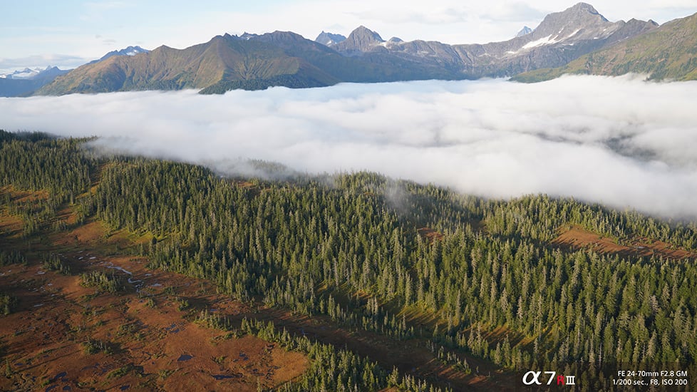 Landscape shot from above clouds with Sony a7R III camera and FE 24-70mm F2.8 GM lens with 1/200 second shutter speed, f.8 aperture and ISO 200 sensitivity