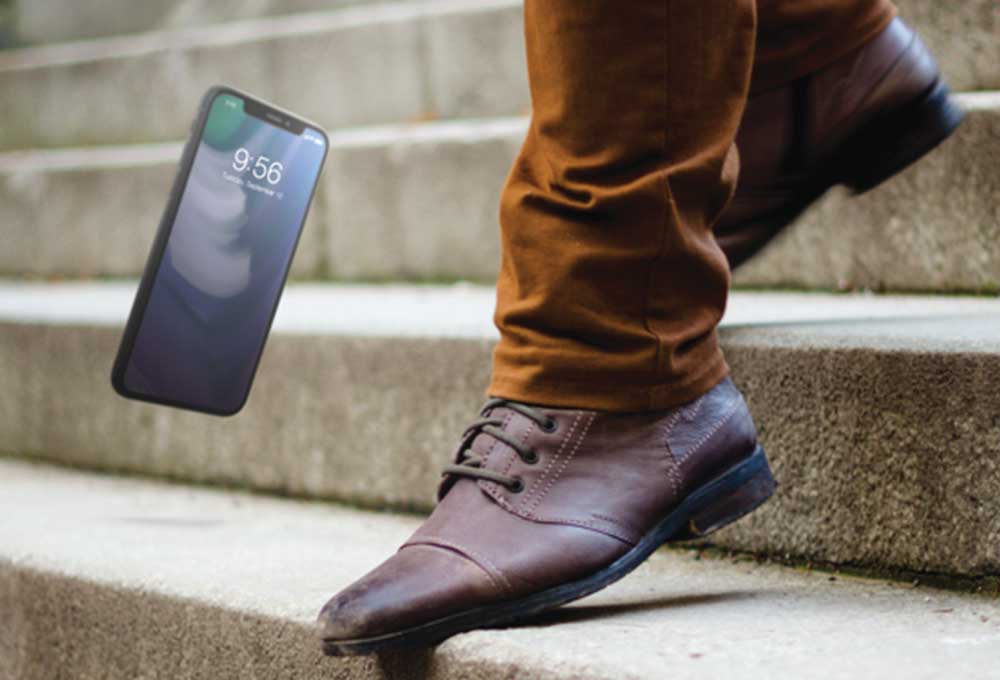 Person dropping phone on steps, invisible shield