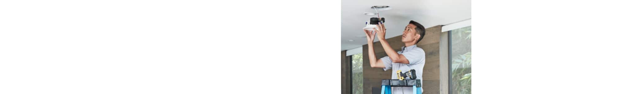 Man installing ceiling speaker