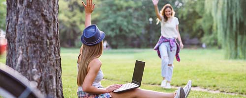 Person using laptop in a park