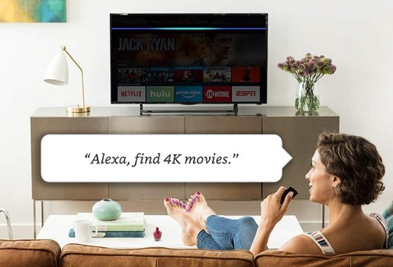 Woman using voice control. "Alexa, find 4K movies."