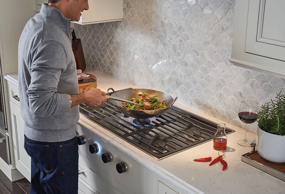 Person cooking on gas rangetop