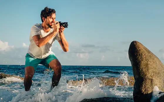 Man taking pictures on beach