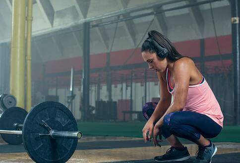 Woman wearing headphones at the gym