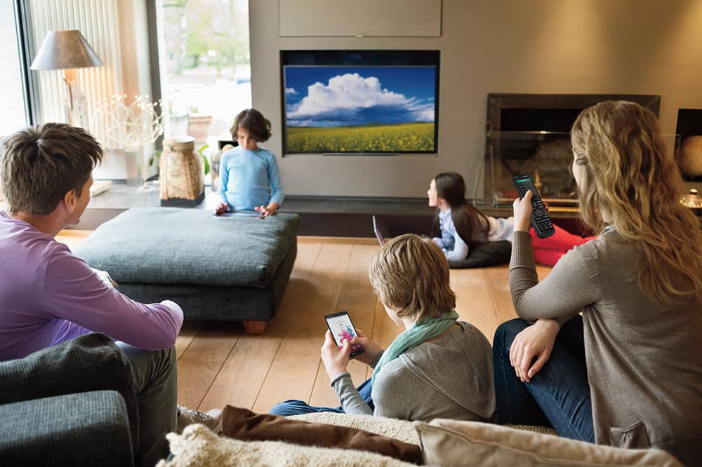 family watching electronic devices