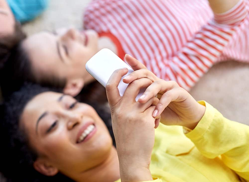 Teenage girls using cell phones