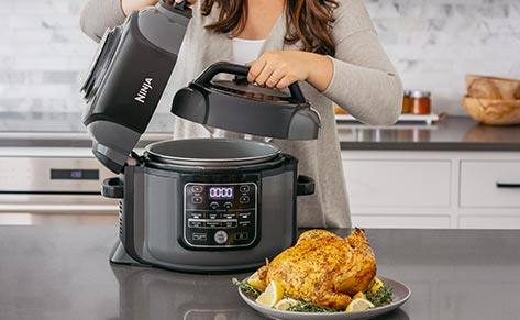 Person using multicooker, cooked chicken