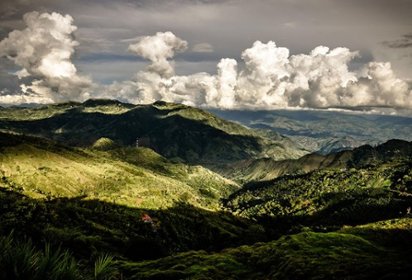 Landscape image of mountains with clouds in the background