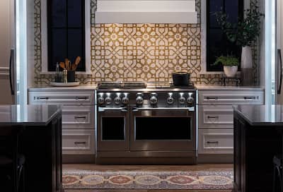 Range in modern kitchen with tile backsplash