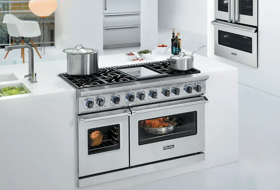Stainless steel appliances in white kitchen