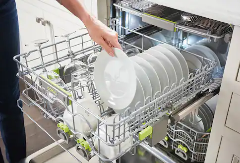 Person unloading dishwasher