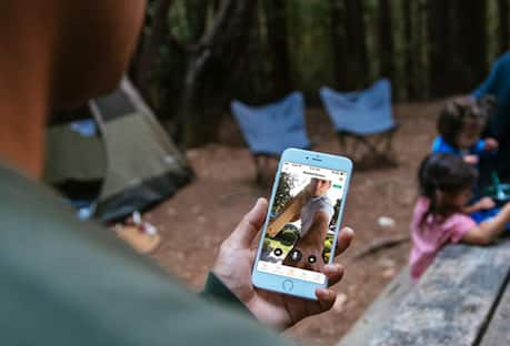 Checking smartphone at campsite