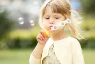 girl blowing bubbles