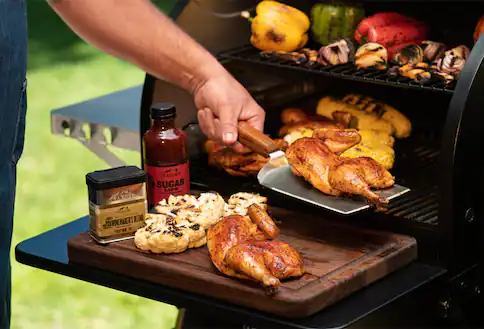 Person with food on spatula and condiments