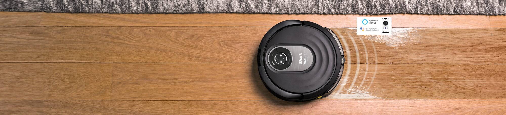Robot mop cleaning hardwood floor adjacent to rug. Works with Alexa. Works with the Google Assistant.