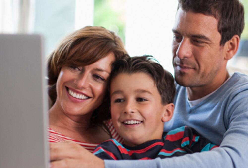 Family in front of laptop