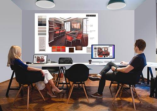 Business projector displaying computer image on wall of small office