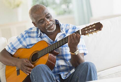 Senior playing guitar