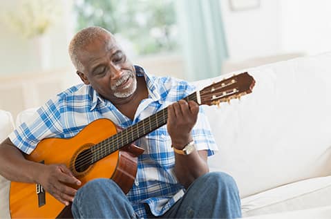 Senior man playing guitar