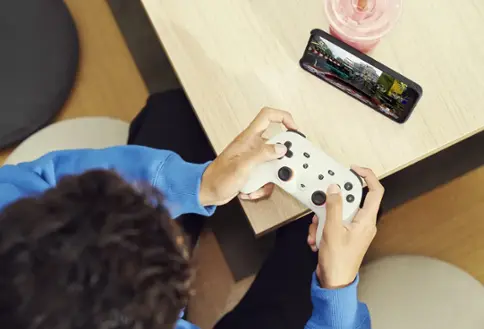 Person playing video games on smartphone