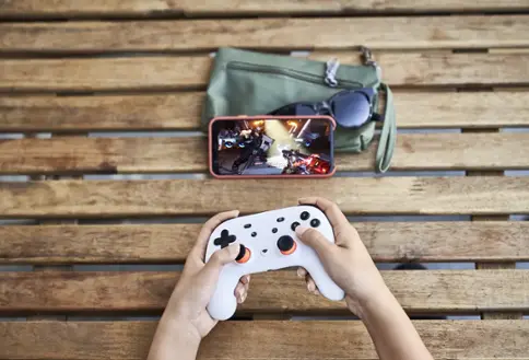 Person playing video games on smartphone