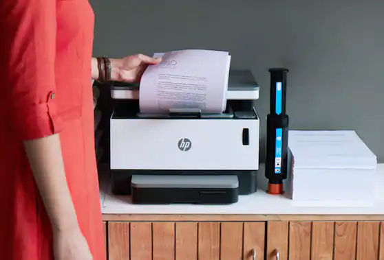 Woman holding paper at printer