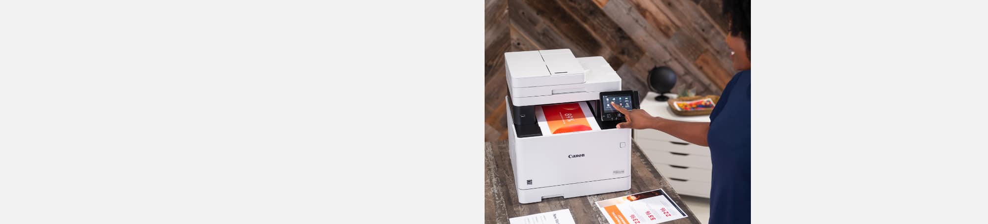 Woman printing color documents at printer