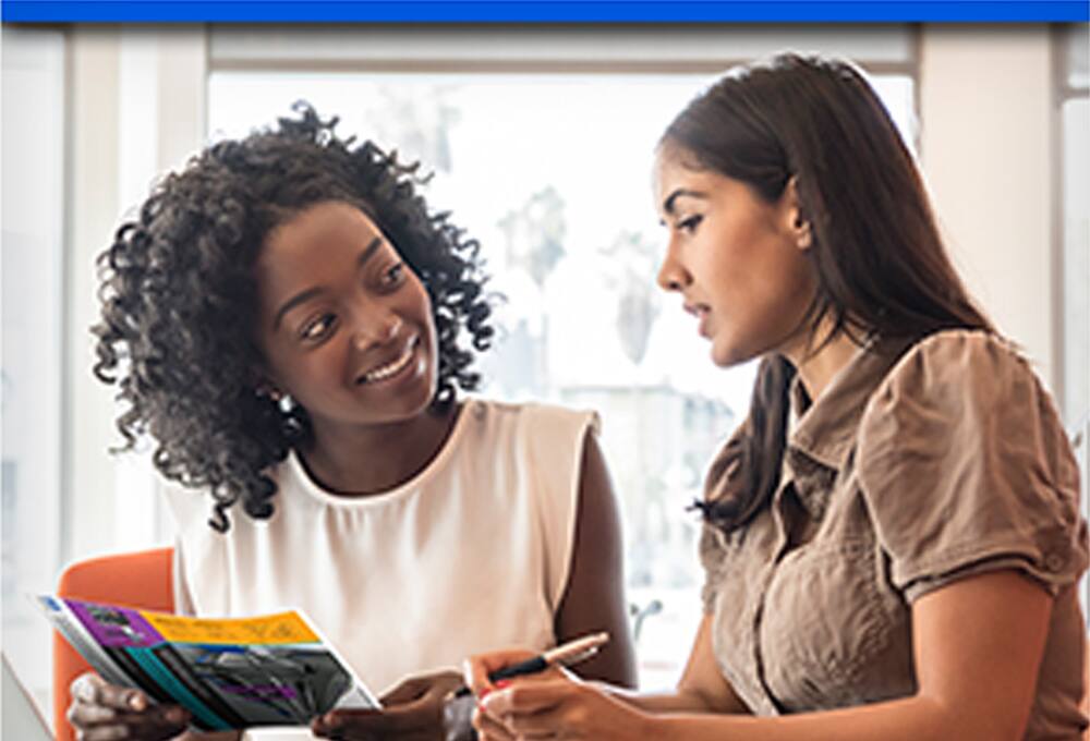 Two women looking at brochure