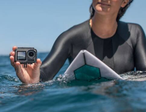 Person on surfboard recording with action camera