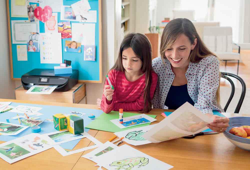 Woman helping child with schoolwork