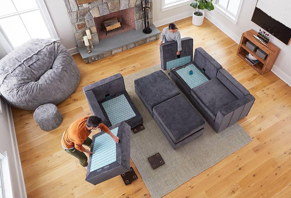 Couple arranging Sactional in living space