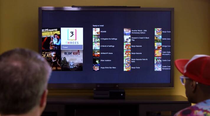 Two men looking at television