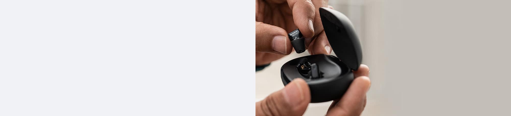 Person holding hearing aids