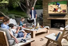 Family watching outdoor TV