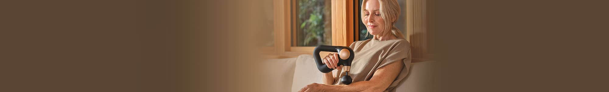 Person using percussion massager