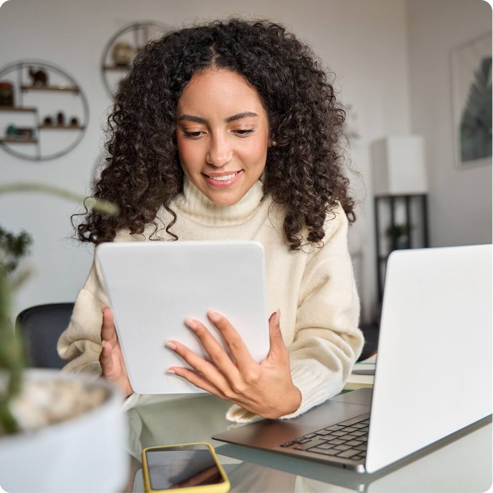 Adult student using tablet and laptop