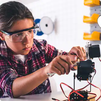 Preteen student working on robot