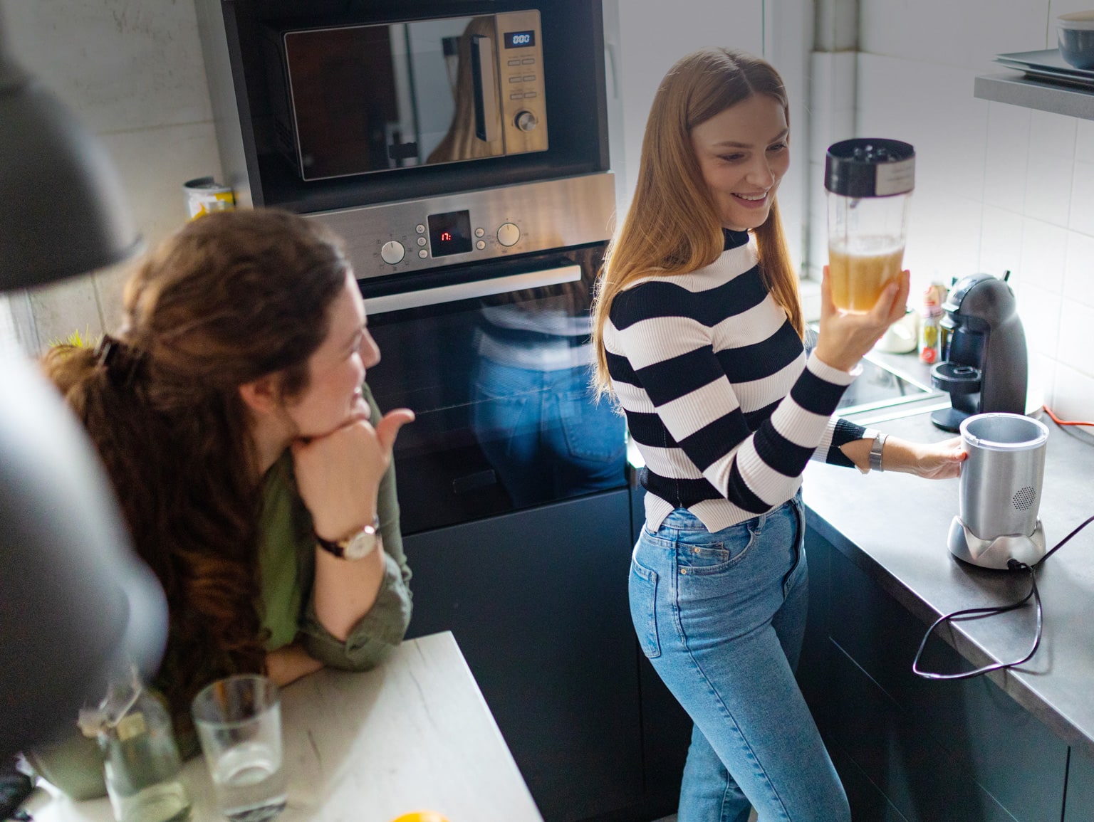 Two students making a smoothie