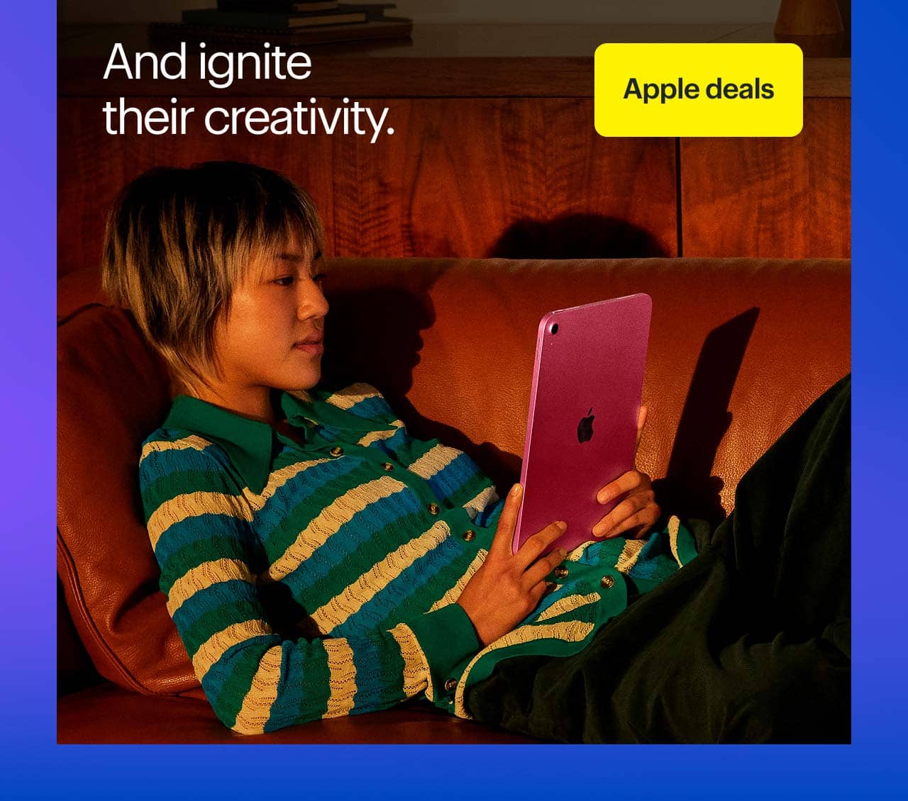 Person using iPad on a couch.