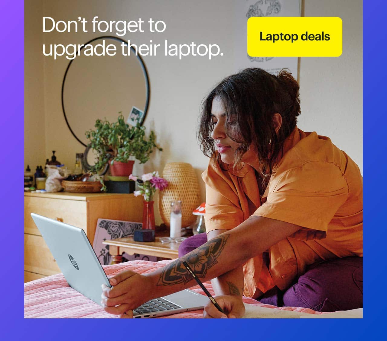 Person using HP laptop in a bedroom.