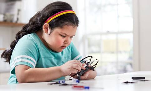 Girl looking at quadcopter