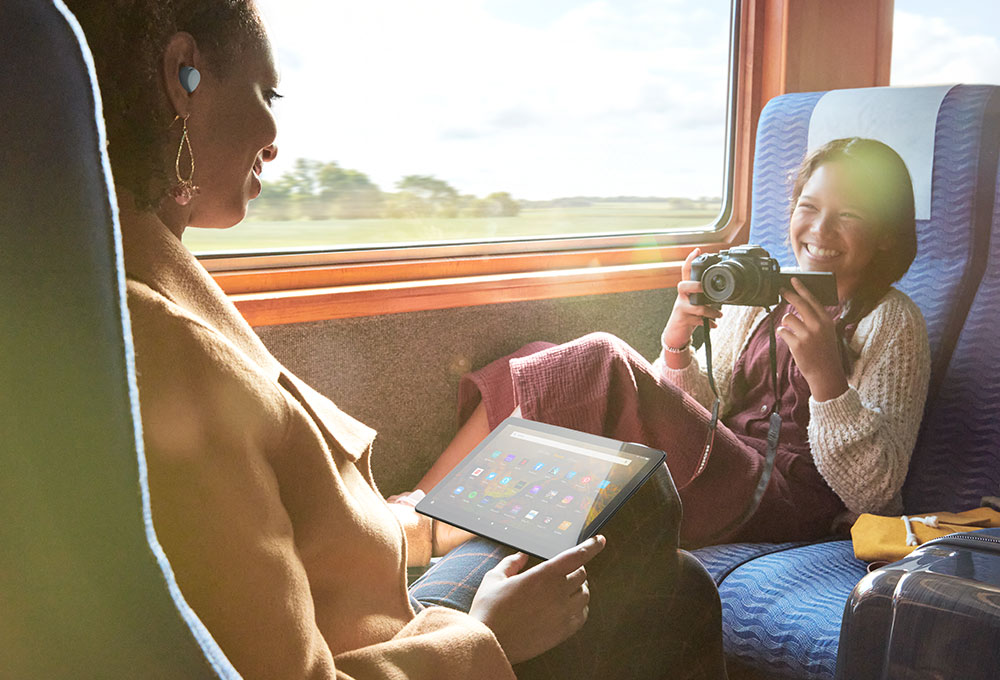 Woman on a train smiling while girl takes picture of her