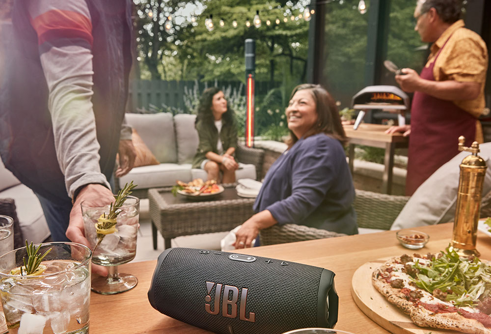 Speaker on table in the middle of an outdoor party