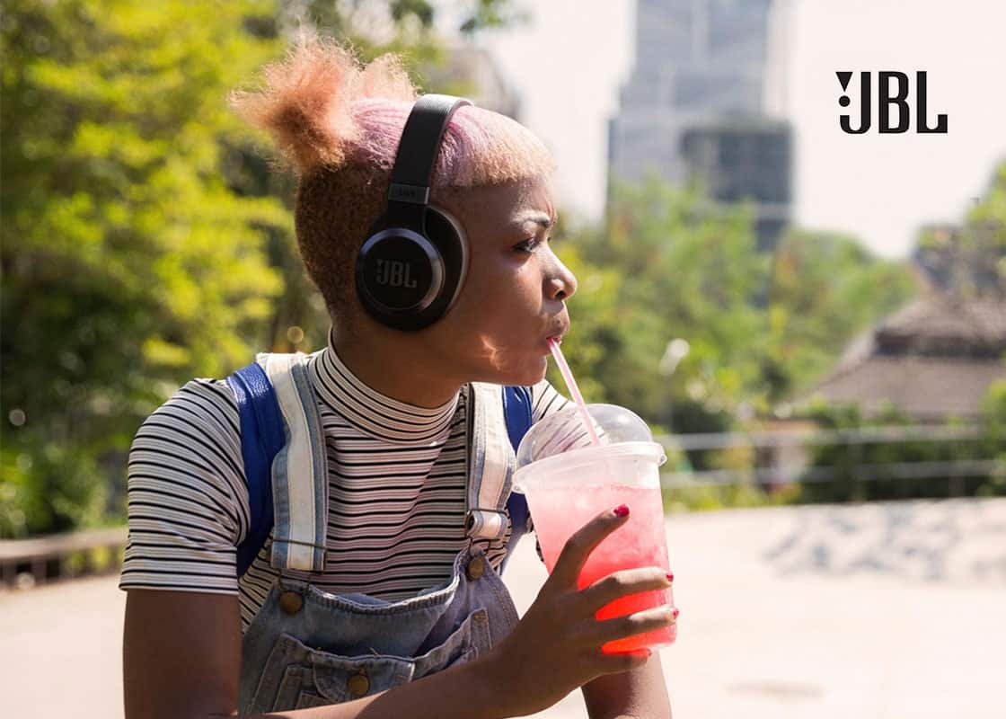 Person wearing JBL Adaptive Noise Cancelling Wireless Headphones.