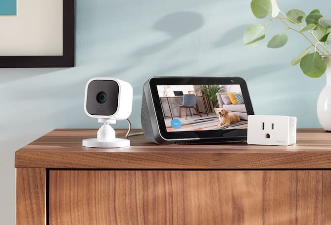 Smart plug, smart display and mini security camera on a table.