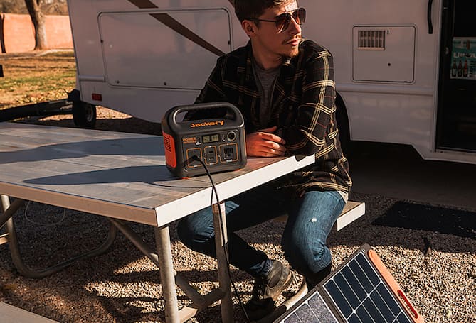 Man charging battery with solar panel