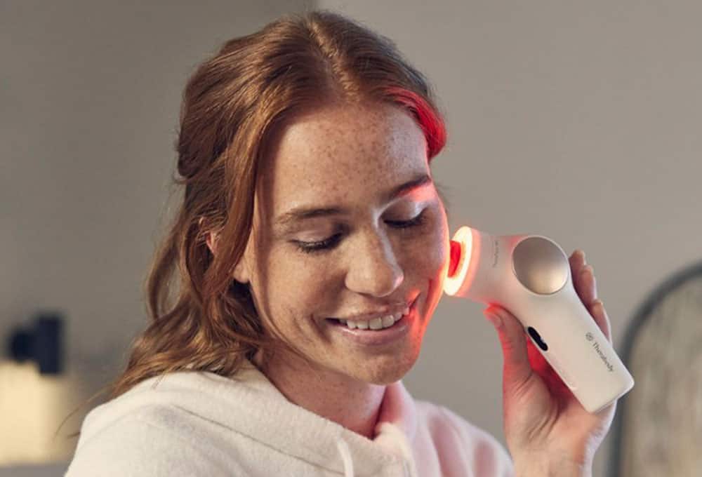 Woman using a facial health device