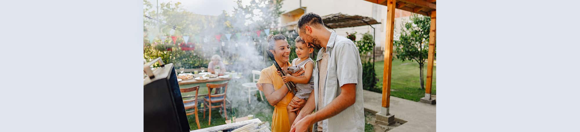 People grilling in backyard