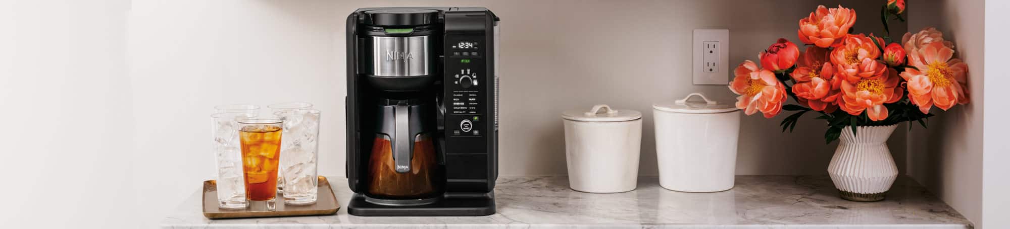 Coffee maker and cold beverages on countertop